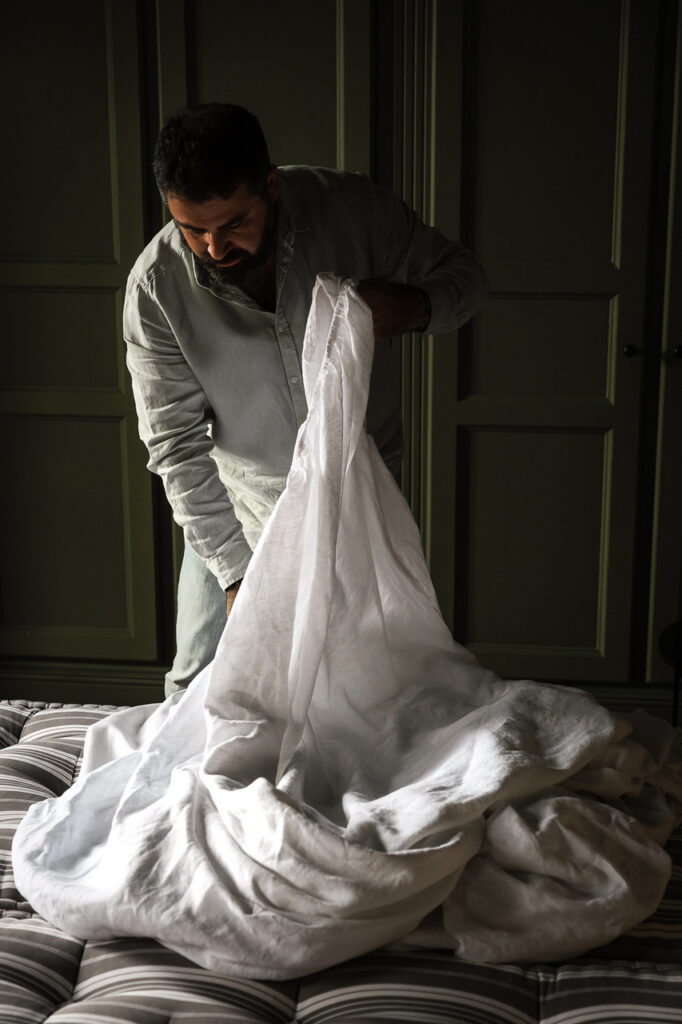 Nicolas owner of Moulin Moulin in Dannes - France, making the bed.